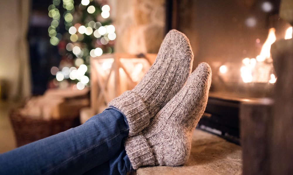 woman staying warm by a fire